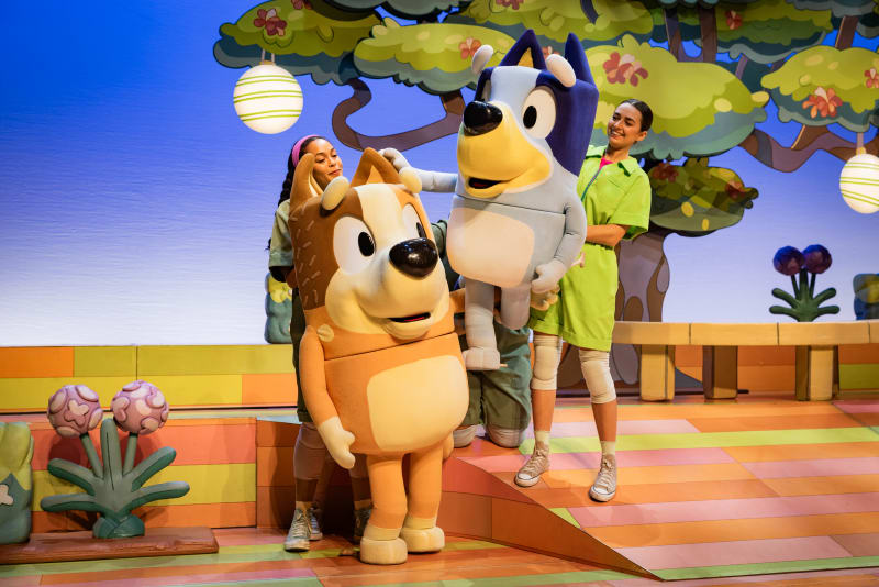 Bluey and Bingo character costumes on a colourful stage set with two performers during Bluey's Big Play UK & Ireland Tour 2025.