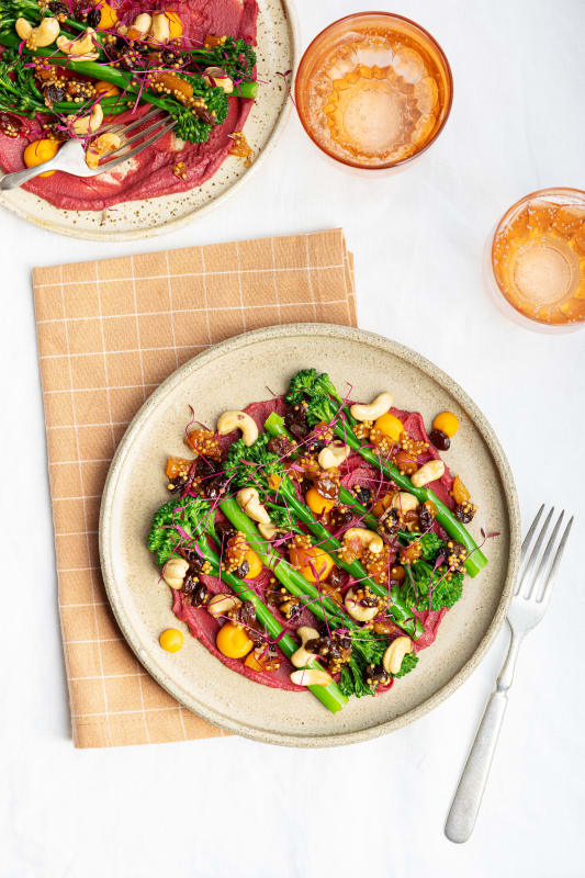 Daniel Lambert's tenderstem broccoli and beetroot hummus dish with cashews, dried fruit, and micro-herbs.