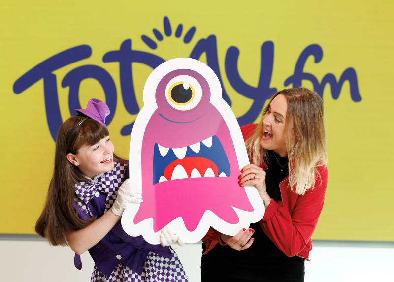 Alice and Alison Curtis hold a pink cartoon monster cutout at the Today FM studios for Children's Health Foundation Trick or Treat 2026 launch.