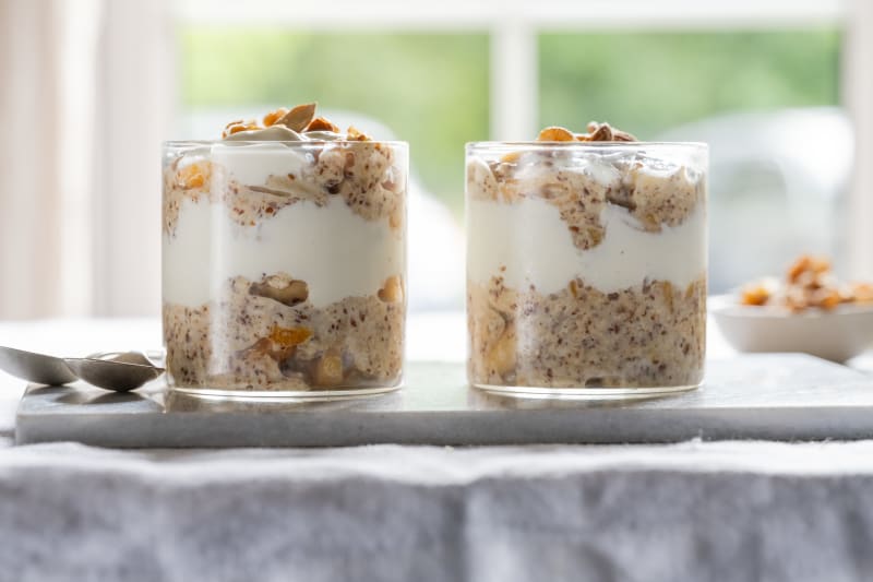 A bowl of Big Nutty Overnight Oats with Greek yogurt, almonds, apricots and honey.